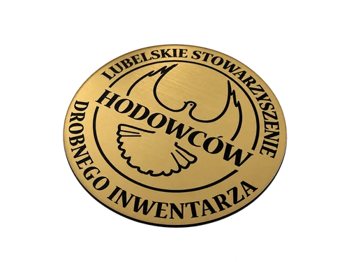Okrągła złota tabliczka z czarnym grawerem nazwy Lubelskie Stowarzyszenie Hodowców Drobnego Inwentarza oraz motywem gołębia.